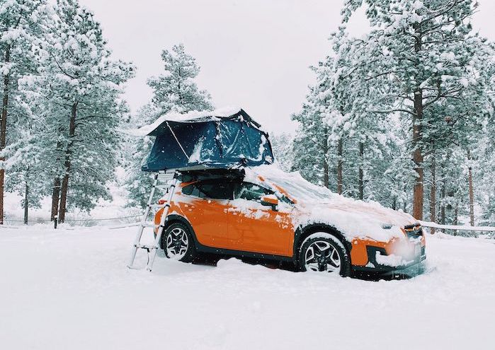 Subaru Crosstrek with a camping tent in the snow