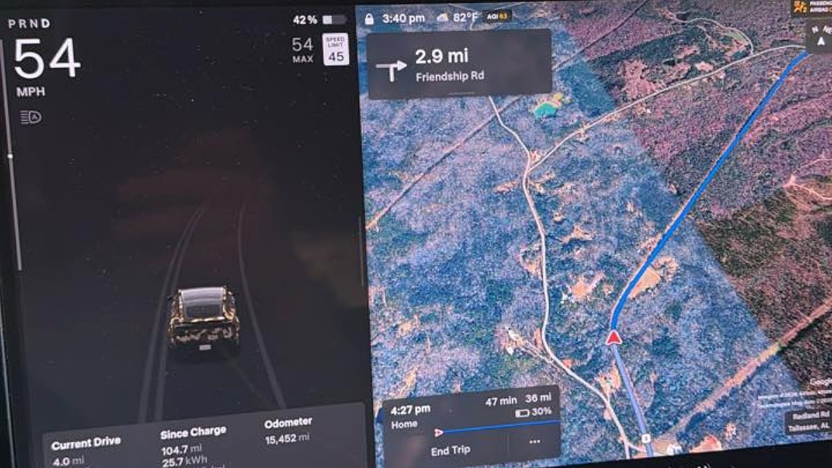 Close-up of Taylor's Tesla Model Y dashboard display. Left screen shows speed at 54 MPH, right screen features a map with a route on Friendship Rd. Clear and sunny.