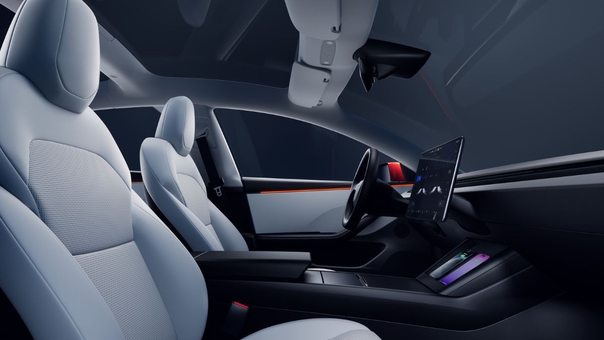Tesla Model 3 interior with modern design, featuring white leather seats, a large touchscreen display on the dashboard, and a panoramic glass roof. Luxurious and futuristic.