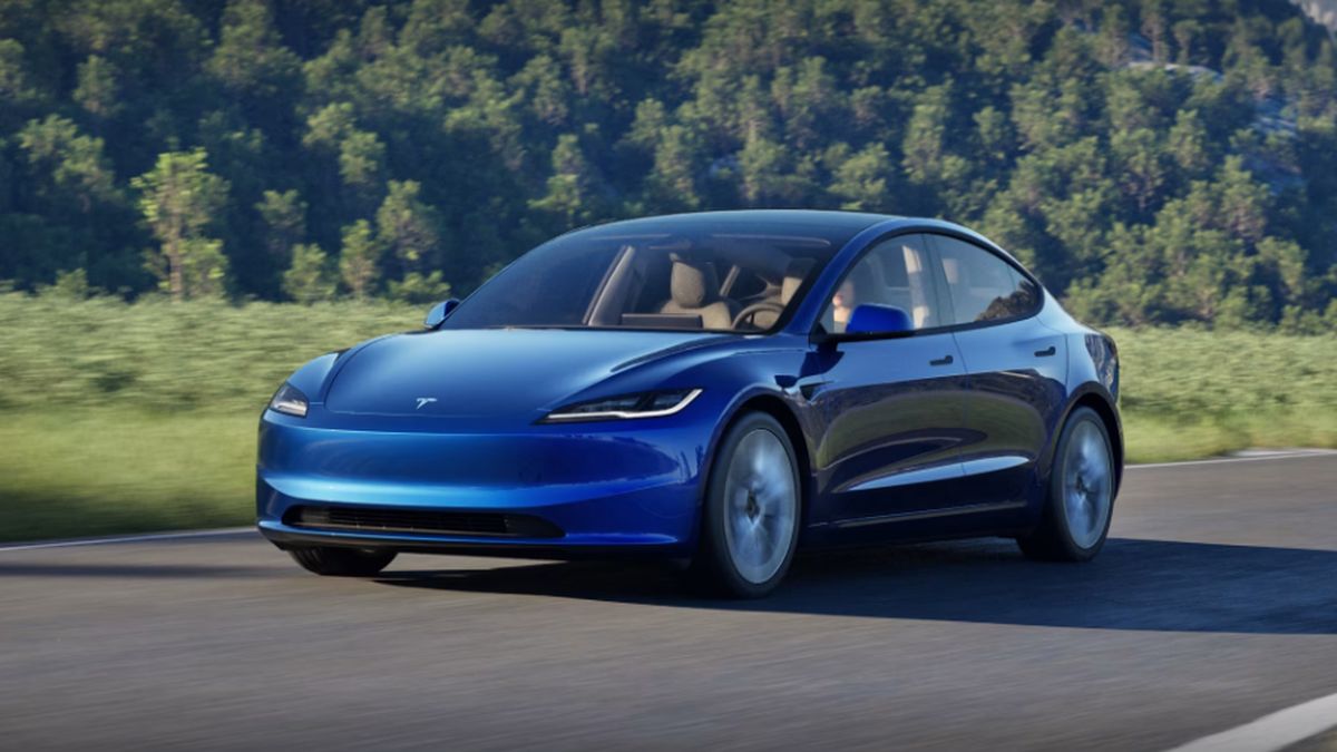 Blue Tesla Model 3 on Highway with blurry lines. 