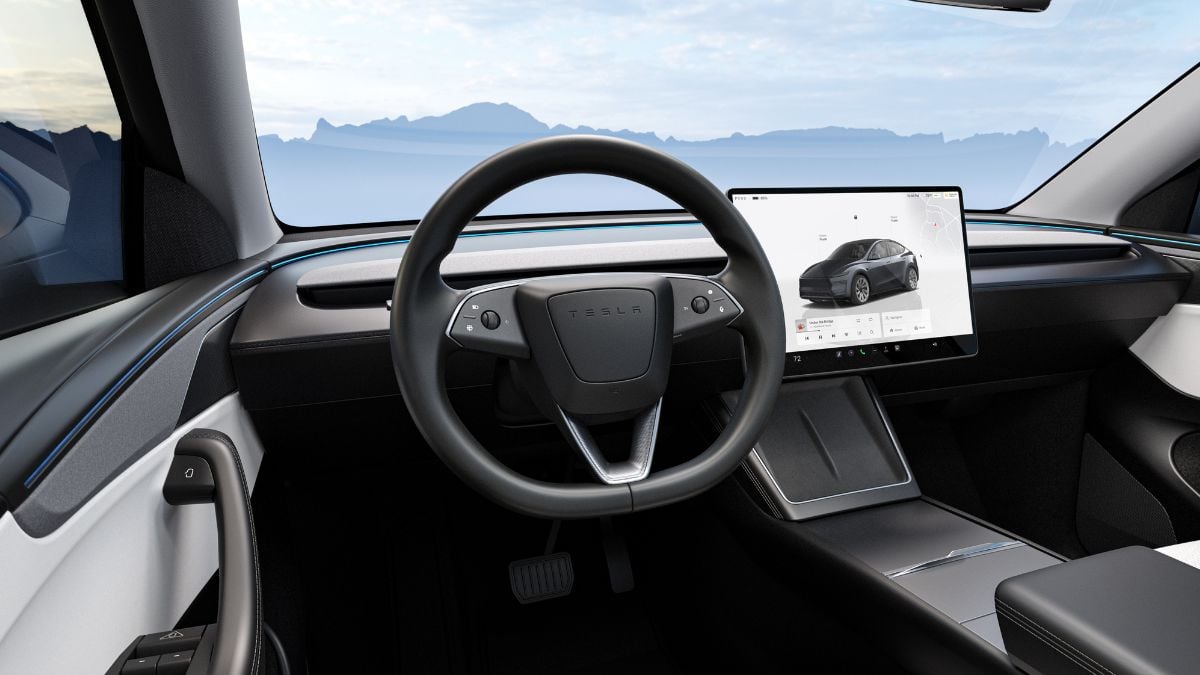 Modern Tesla Model Y interior with a minimalist design, featuring a steering wheel and a large touchscreen displaying a vehicle. Calm, futuristic ambiance.