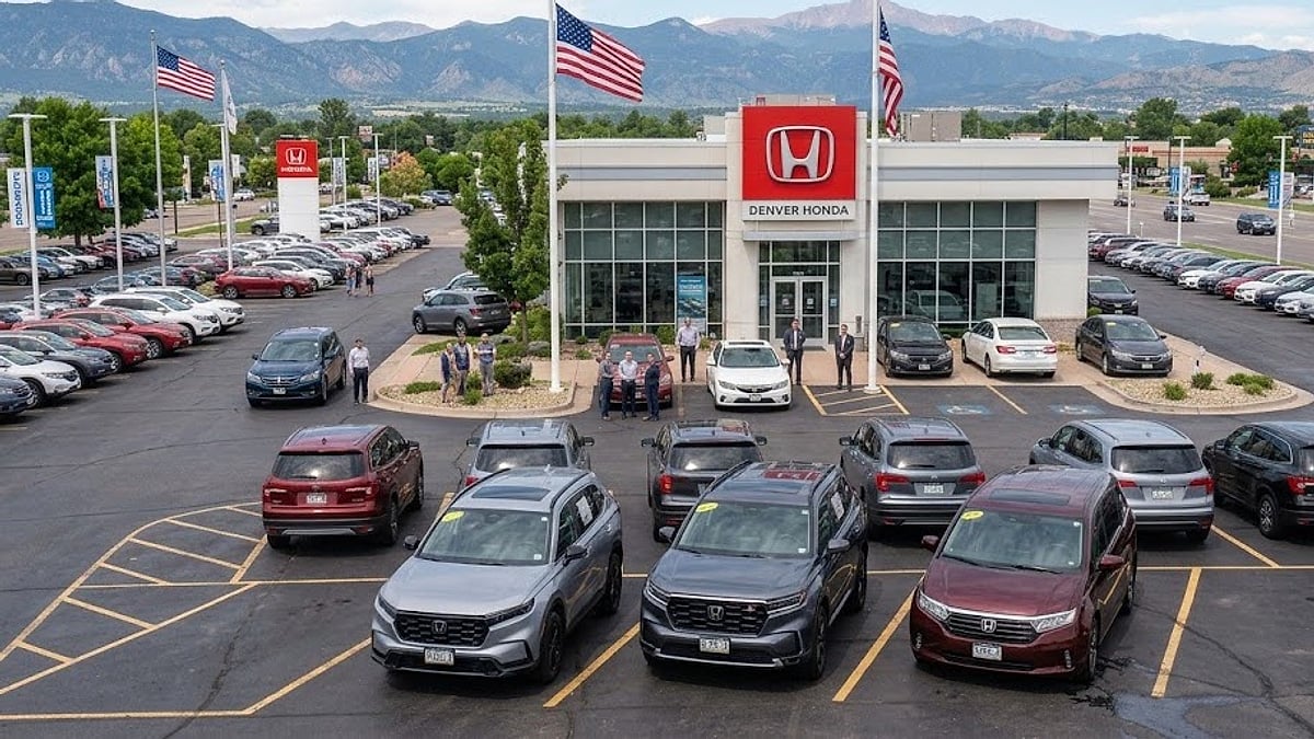 A 2023 Honda CR-V is parked on a dealership lot next to a new 2026 Honda Pilot and a 2026 Honda Odyssey