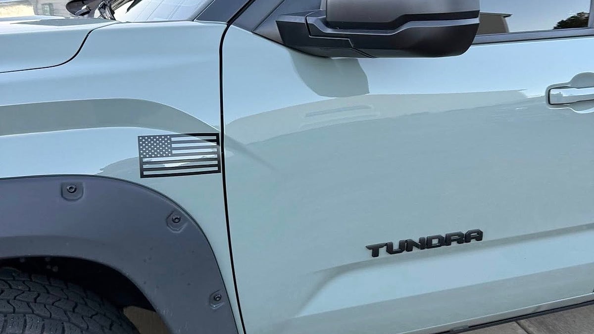  A 2024 SR5 TRD Sport Tundra Lunar Rock dispalying the Tundra badge in a South Carolina driveway