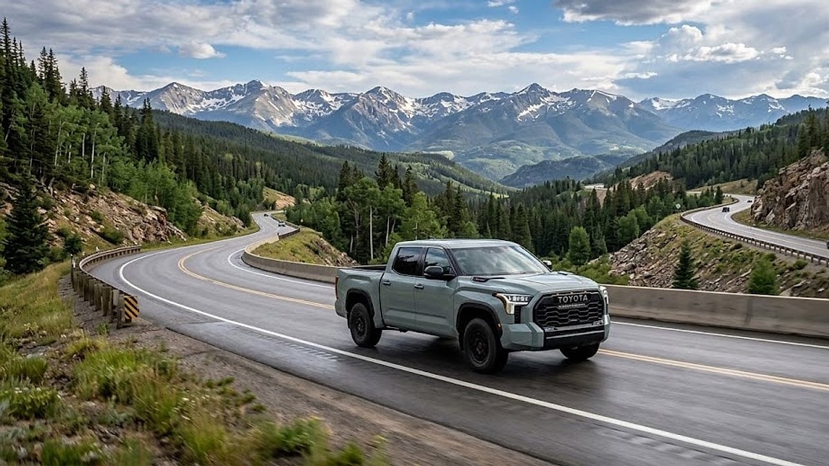 A 2024 Toyota Tundra Limited drives westbound along a sweeping curve on Interstate 70 as it crests Vail Pass in Colorado