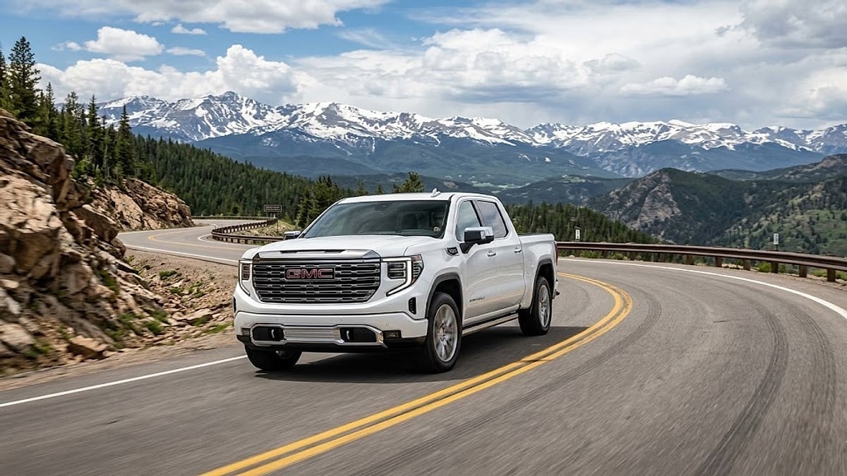 A 2026 GMC Sierra Denali undergoing high-altitude performance testing on a winding Colorado Rocky Mountain road near Vail Pass