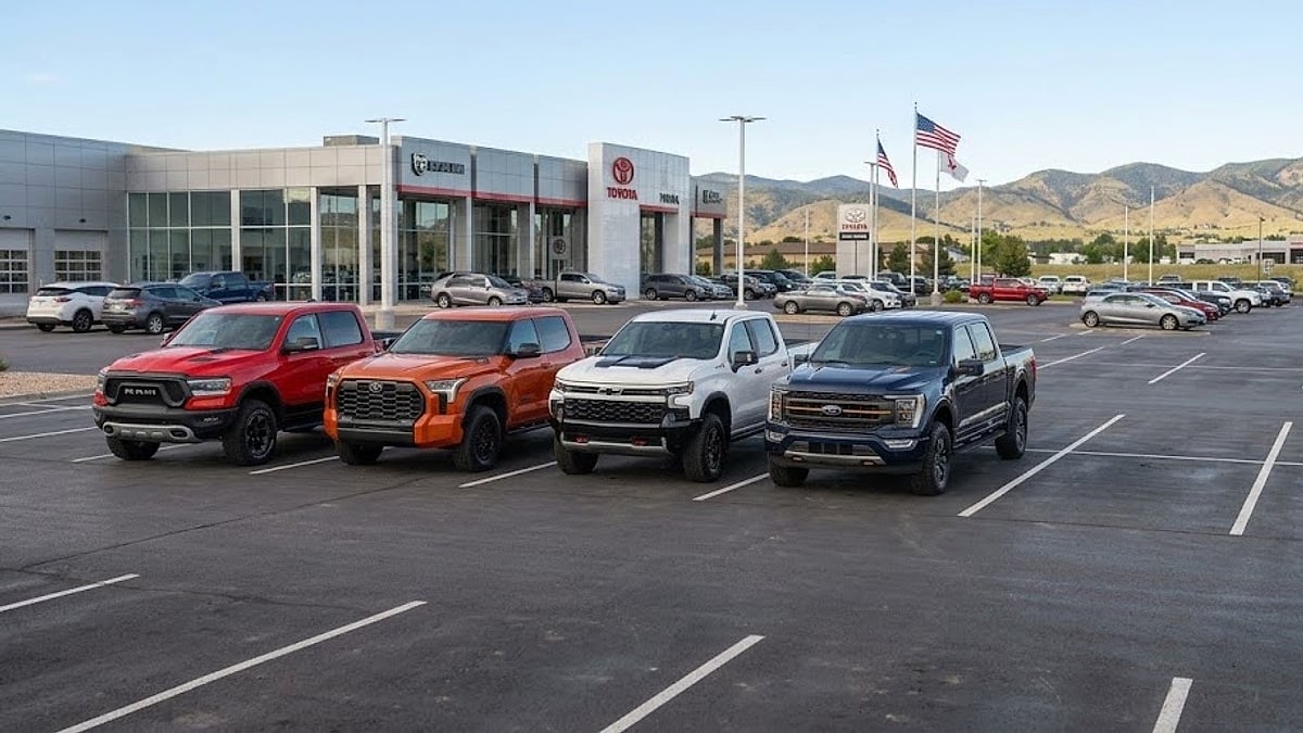 A 2026 RAM Rebel in red, Toyota Tundra TRD Pro in Solar Octane, Chevy Silverado ZR2 in White, and Ford F-150 Tremor in Blue are parked cleanly on a dealer lot for a side-by-side comparison in Parker, Colorado