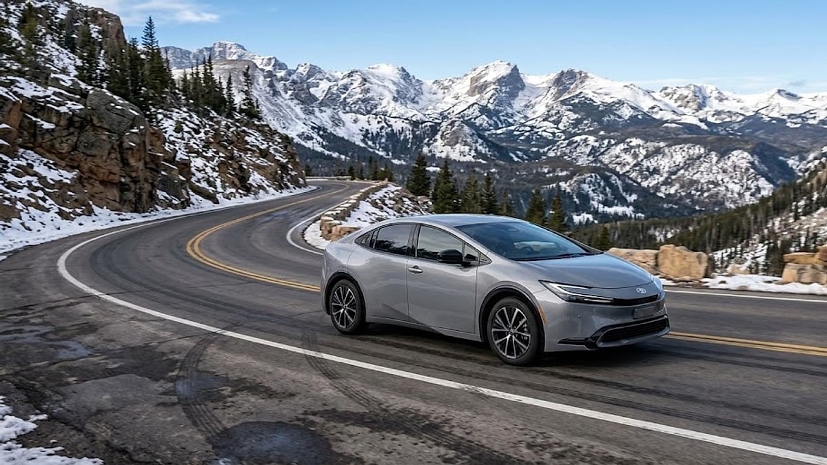 A 2026 Toyota Prius XSE Premium in Guardian Grey navigates a snow-dusted Colorado mountain pass on 19-inch alloy wheels