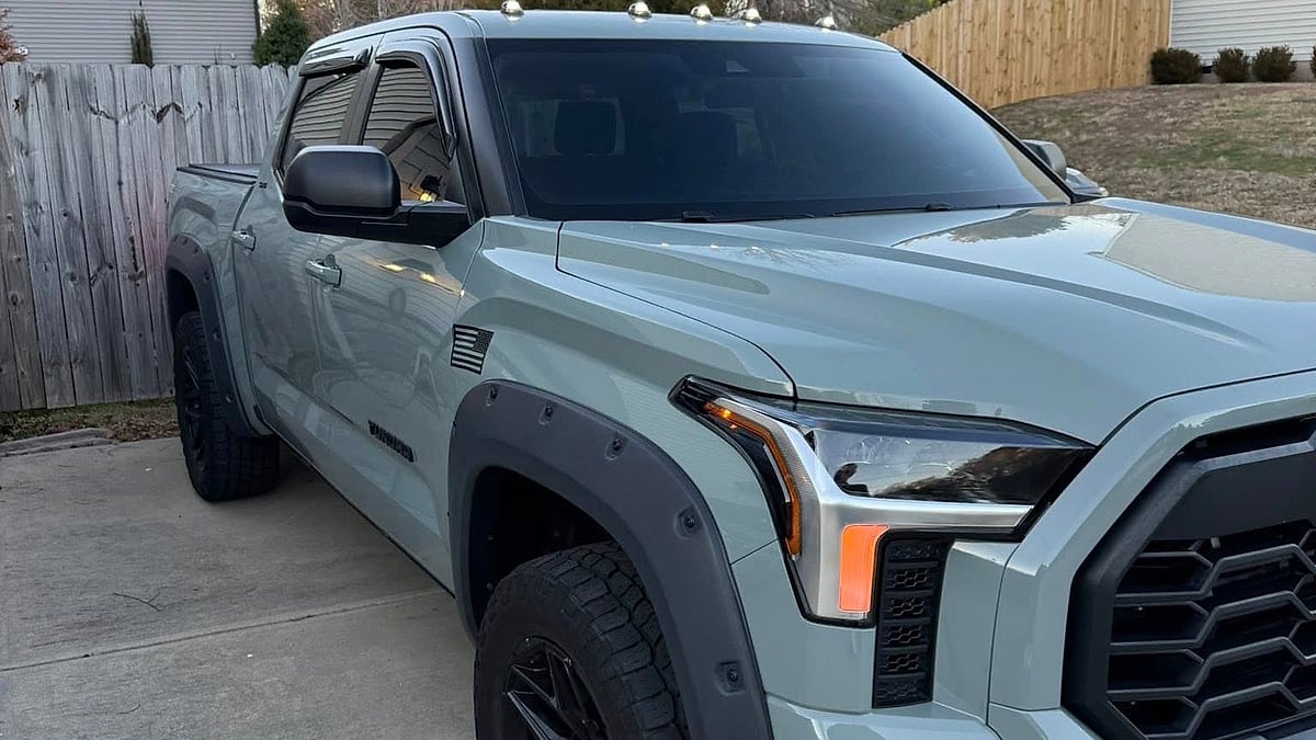 A 2026 Toyota Tundra CrewMax is parked in a scenic, residential South Carolina driveway under oak trees