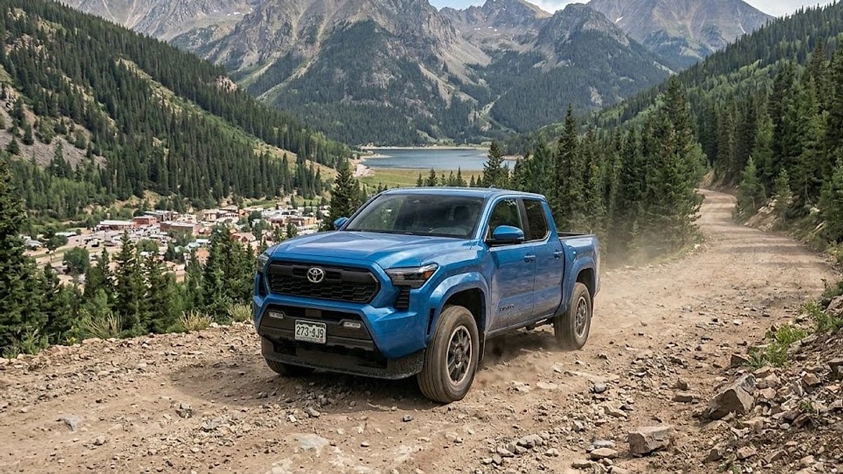 A 4th-Gen Toyota Tacoma traverses a rugged Colorado mountain dirt road, testing electronic transmission shift maps and off-road chassis durability