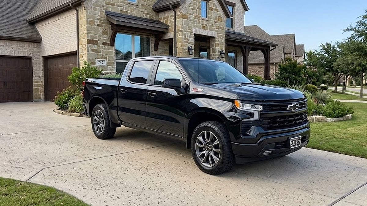 A black 2026 Chevrolet Silverado RST parked in a suburban Texas driveway highlights emerging electronic shifter and transmission software vulnerabilities