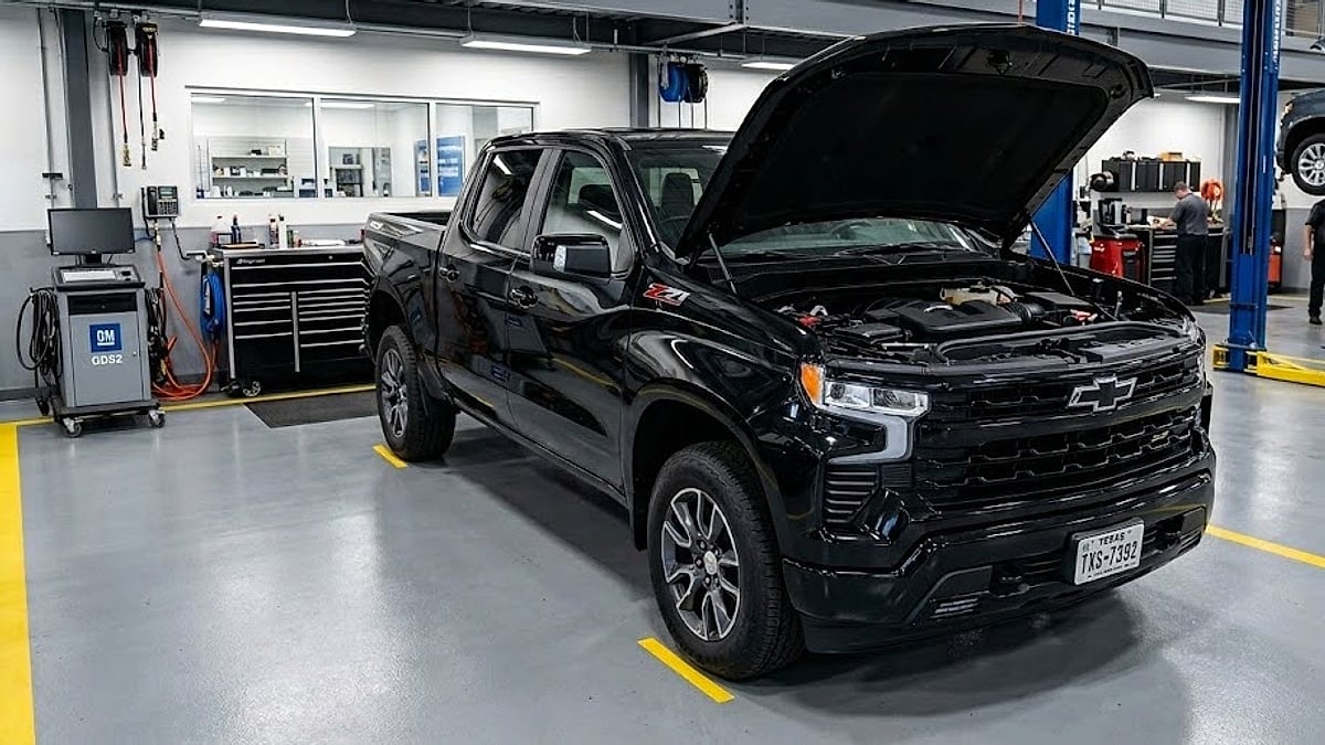 A black 2026 Chevy Silverado with a Texas license plate sits in a dealership service bay for advanced network diagnostic testing