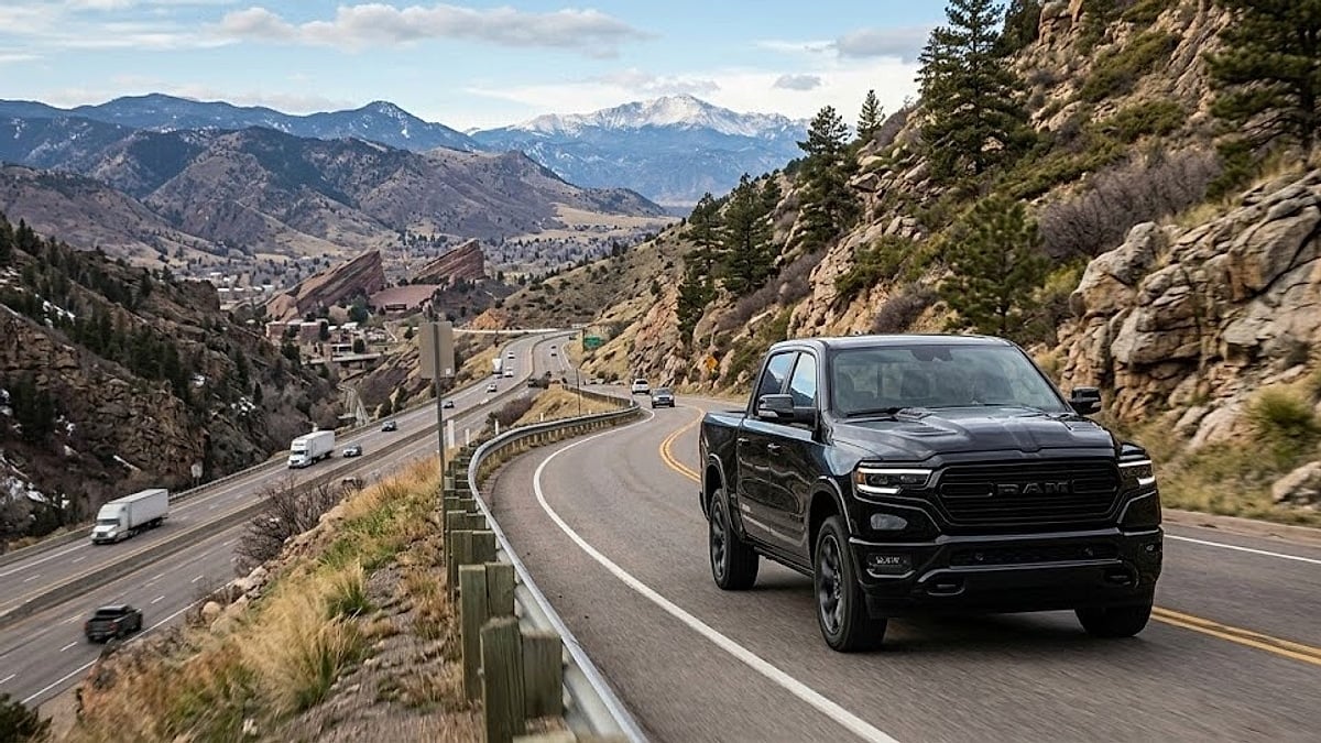 A black 2026 Ram truck drives up the steep Mount Vernon Canyon near Morrison, Colorado, past Red Rocks Amphitheatre