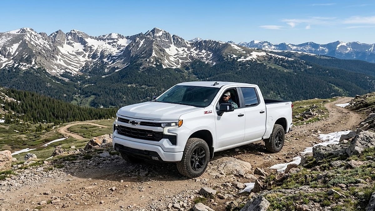 A new white 2026 Chevrolet Silverado Z71 navigates a rugged, high-altitude mountain pass during vehicle testing in the Colorado Rockies