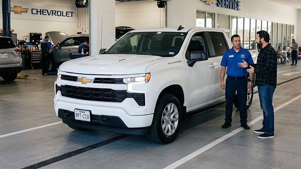 A new white 2026 Chevy Silverado 1500 undergoes electrical diagnostics for parasitic 12V battery drain in a dealership service drive