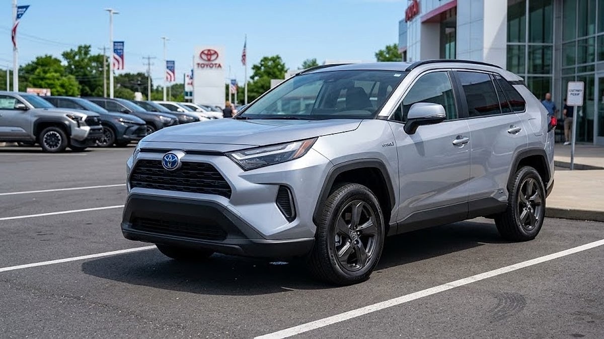 A 2026 Toyota RAV4 Hybrid parked in a dealership delivery bay, showcasing the clean lines of the new model
