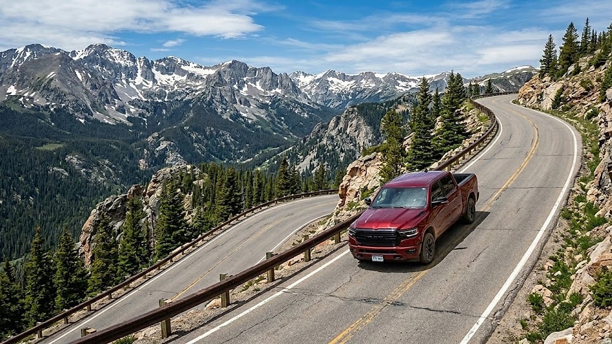 A red Ram 1500 truck with eTorque navigating a steep, high-altitude Colorado mountain highway with heavy regeneration