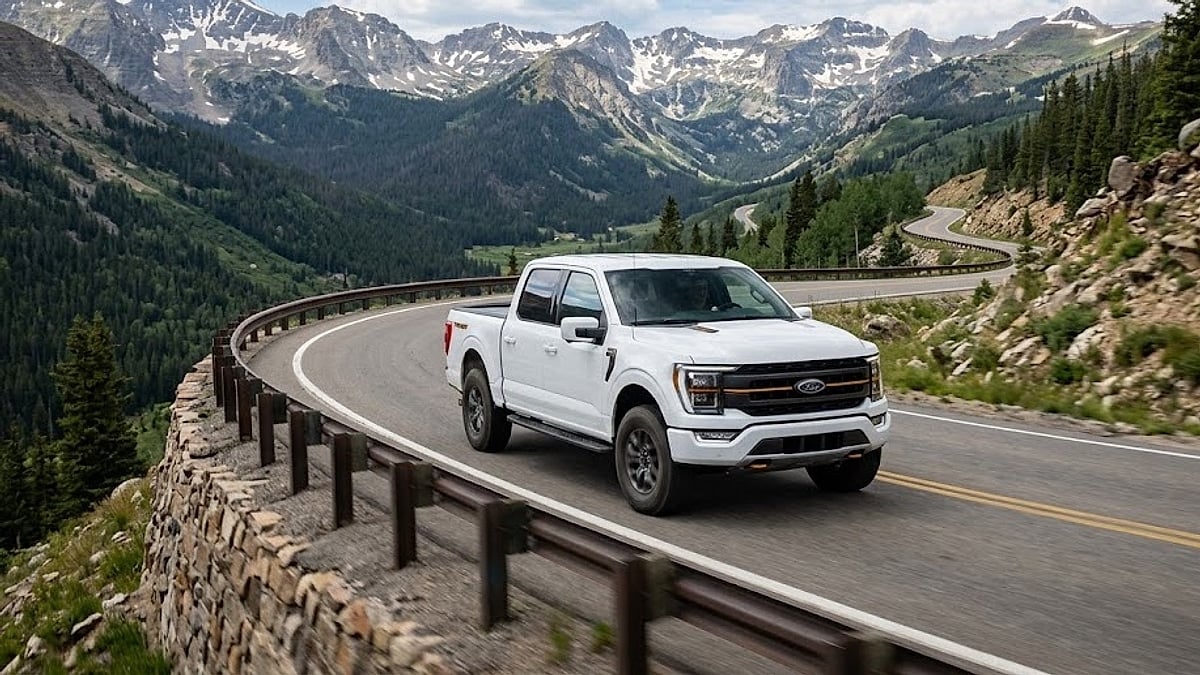 A rugged 2026 Ford F-150 Tremor handles a winding mountain pass road deep in the spectacular Colorado Rockies
