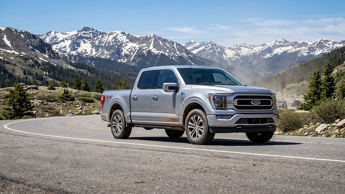 A silver 2025 Ford F-150 navigates high-altitude Colorado roads, demonstrating the 5.0L V8’s capability in thinner air conditions