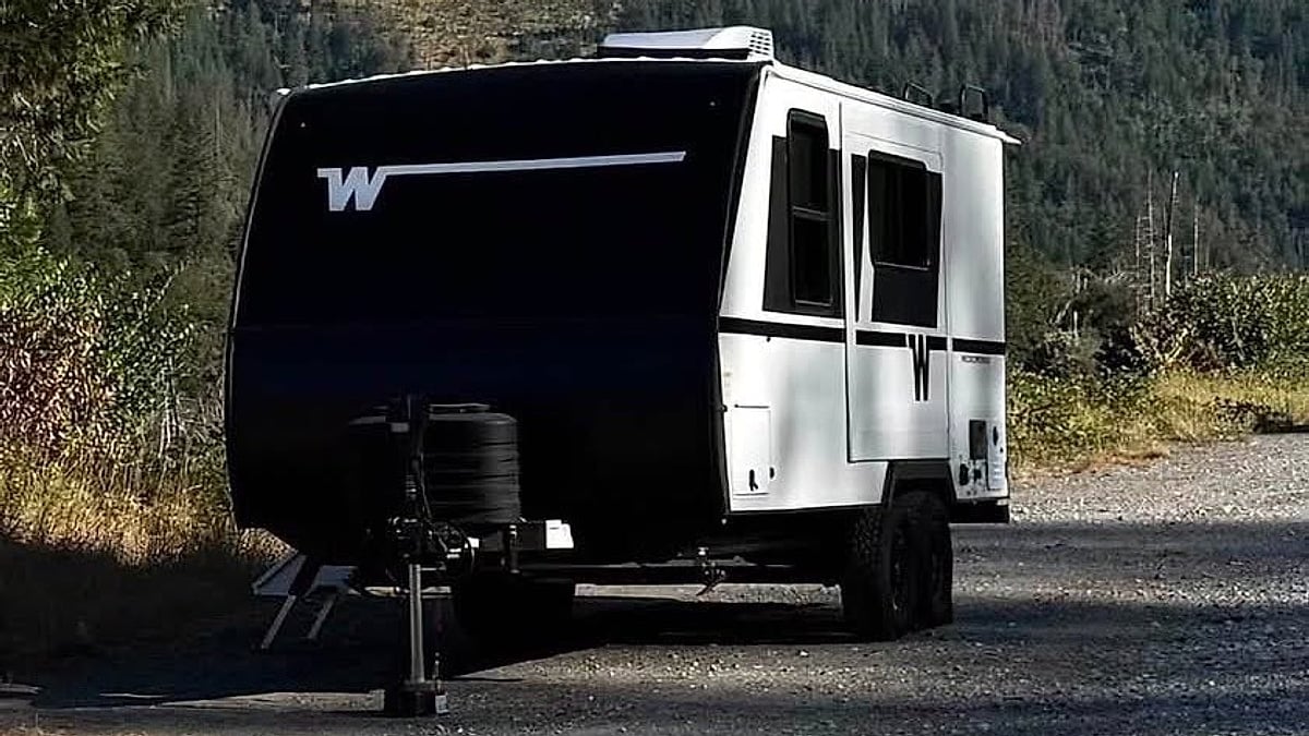 A travel trailer sits on the side of the road waiting to be towed back to town after 2024 Tundra engine failure