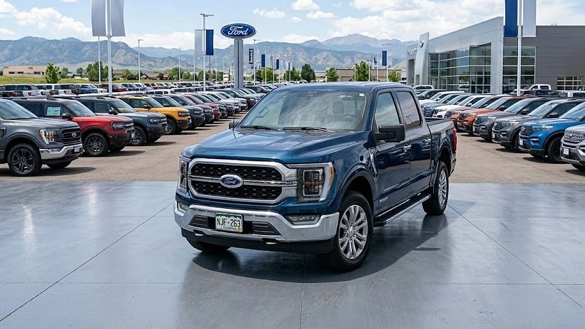 An antimatter blue 2026 Ford F-150 Lariat SuperCrew pickup sits on a paved dealer lot with NJF 263 license plate, showing modern styling