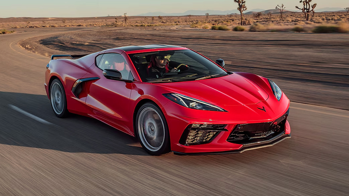 Red Chevrolet Corvette C8 driving on desert road