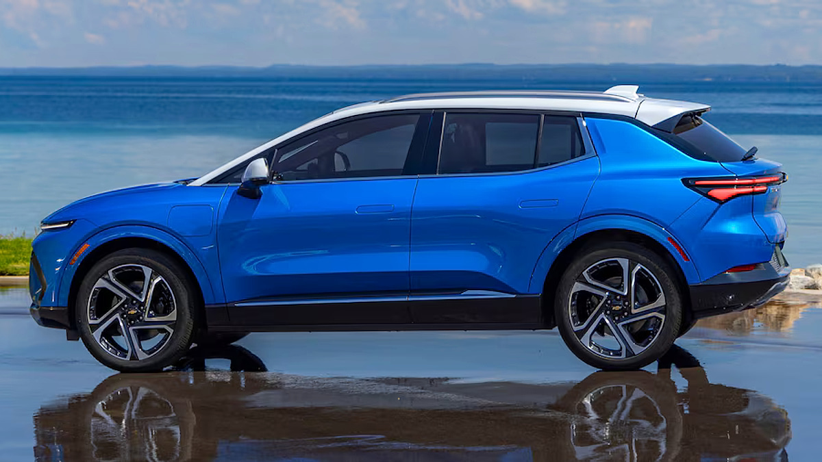 Chevrolet Equinox EV side profile in blue with ocean background