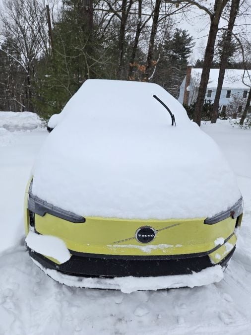 An EV sits buried in snow