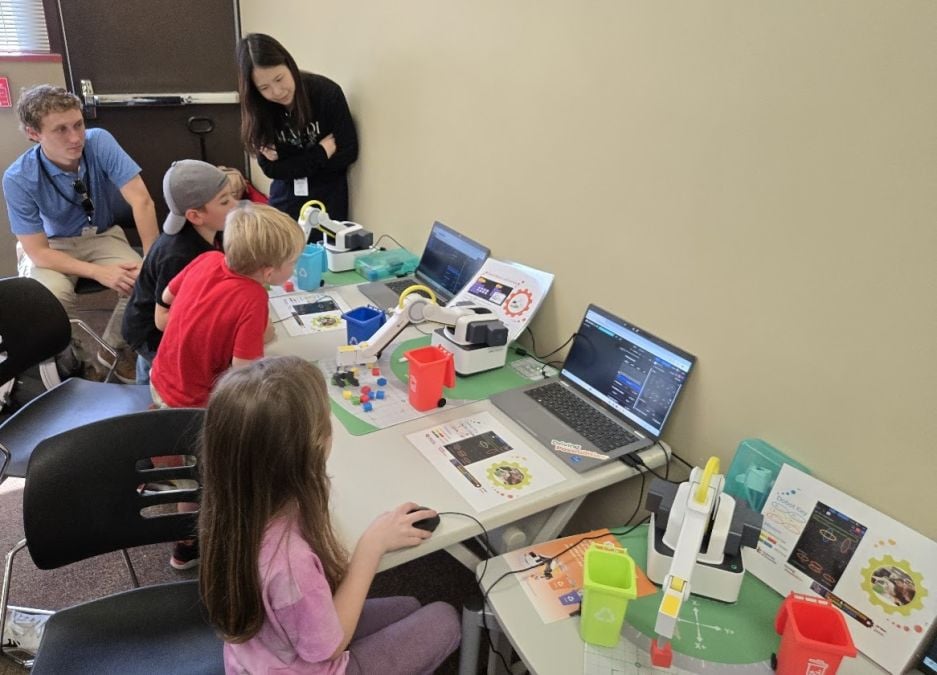 Students in a first grade TEM class sponsored by Toyota learn to program robots