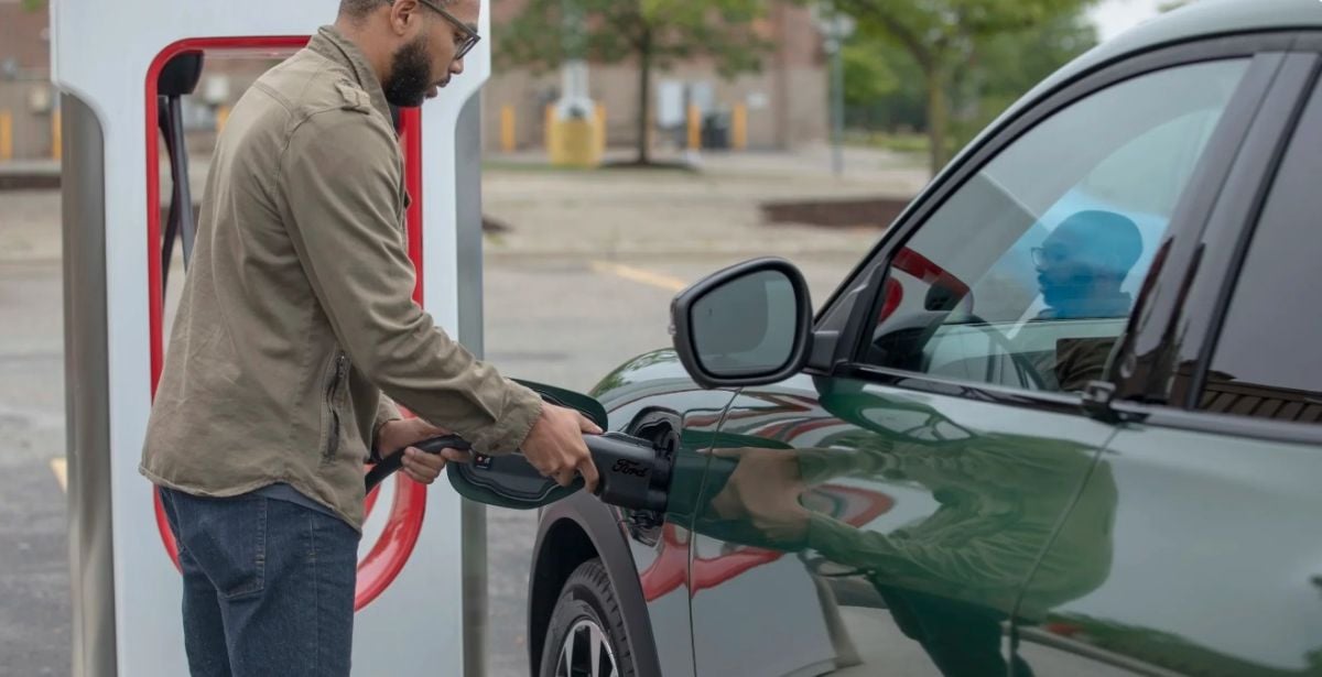 A Ford charges at the Tesla Supercharger network