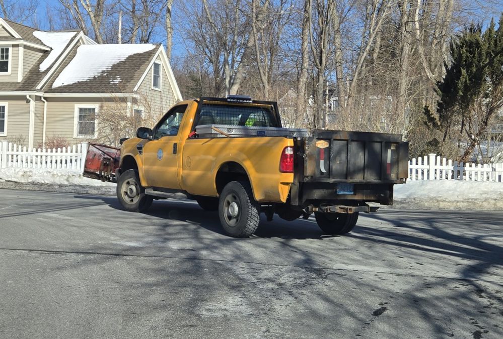 A municipal plow truck in action
