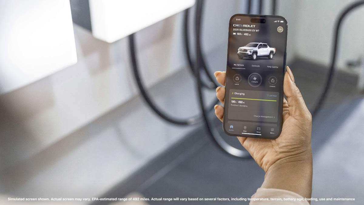A smartphone showing the 2025 Silverado EV WT’s range of 492 miles on the myChevy app.