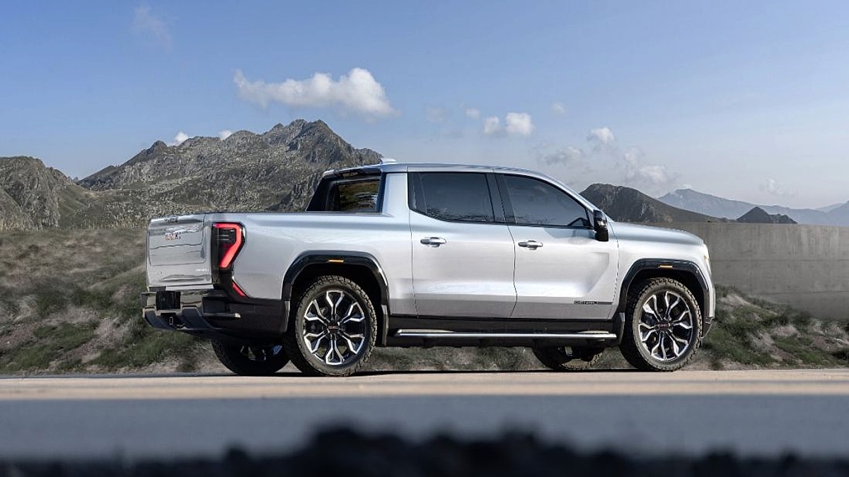 GMC Sierra Denali truck side profile parked near mountains under a clear sky