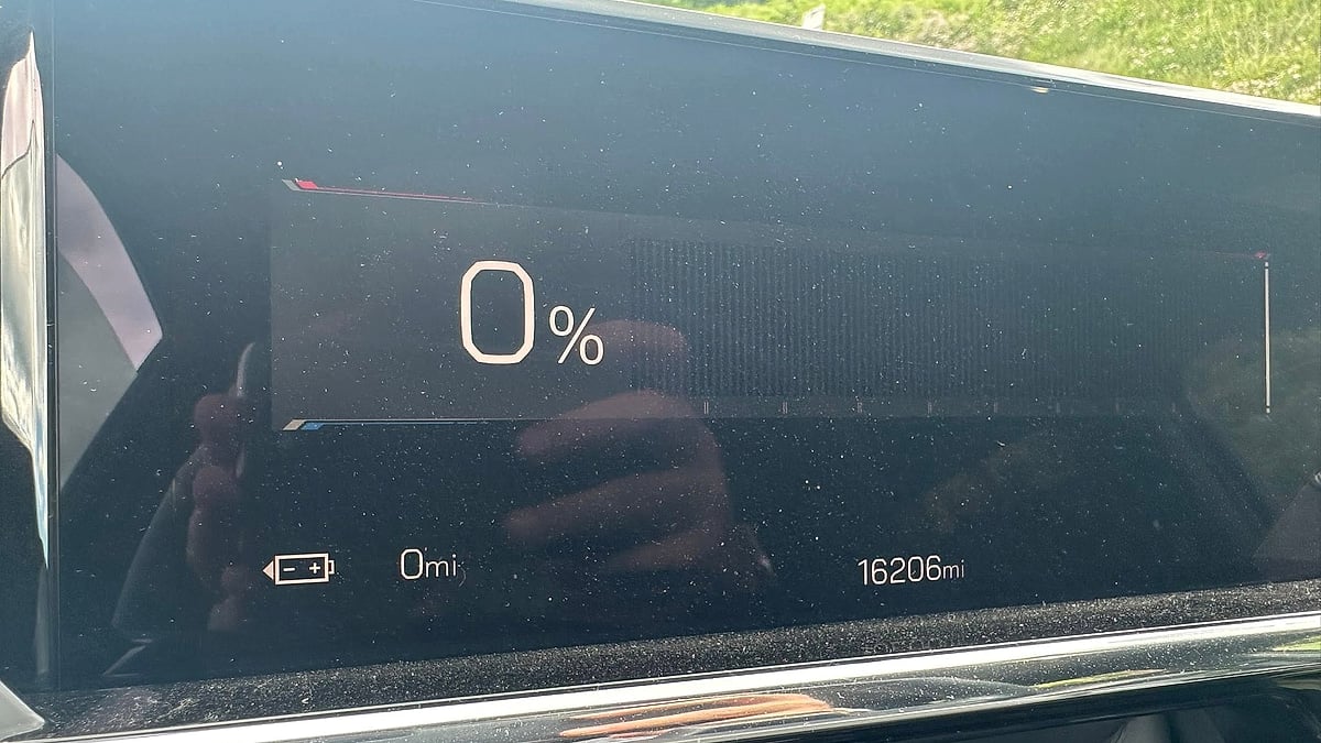 Close-up of a GMC Sierra EV battery display showing 0 percent charge and 0 miles of estimated range.