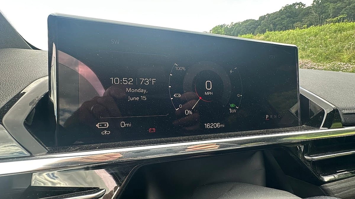 GMC Sierra EV dashboard display showing 0 miles of range, 0 mph, 16,206 miles, and a low battery warning.