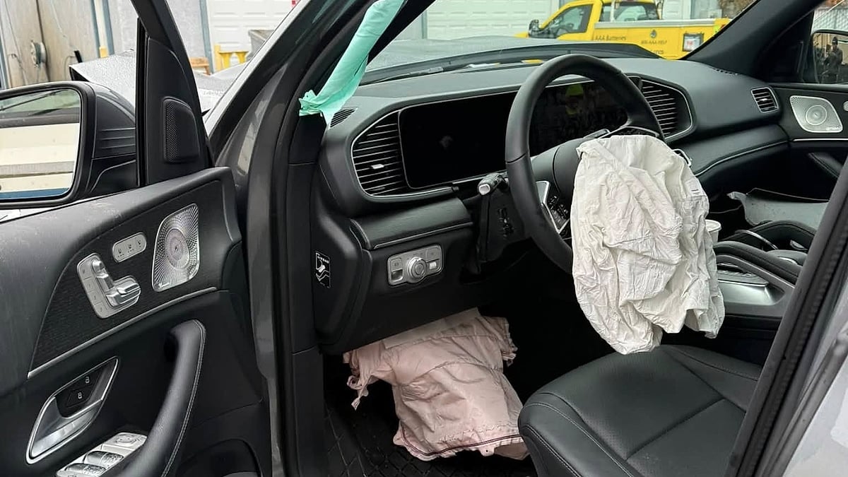 Interior of Laura’s Mercedes GLE 450e showing deployed airbags after a serious highway collision.