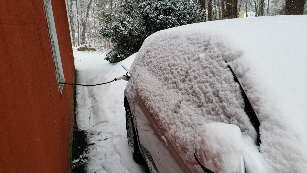A Hyundai Ioniq 5 is charging in ice and snow