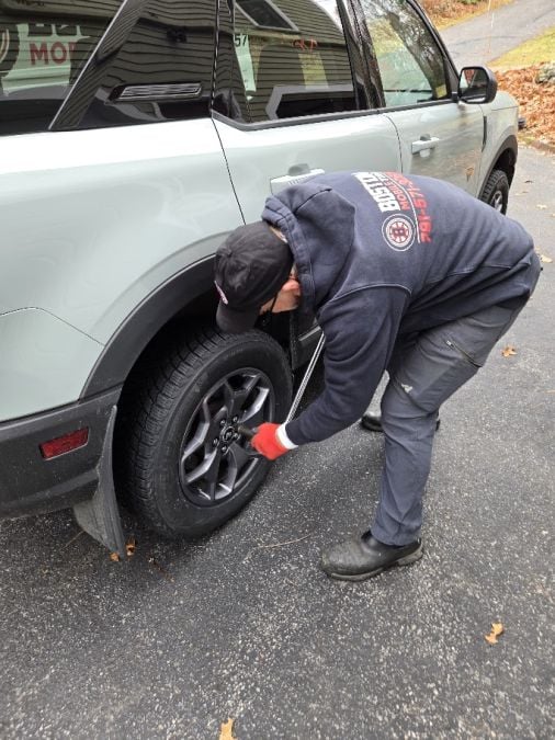 Jay Condrick of Boston mobile Tire uses a torque wrench