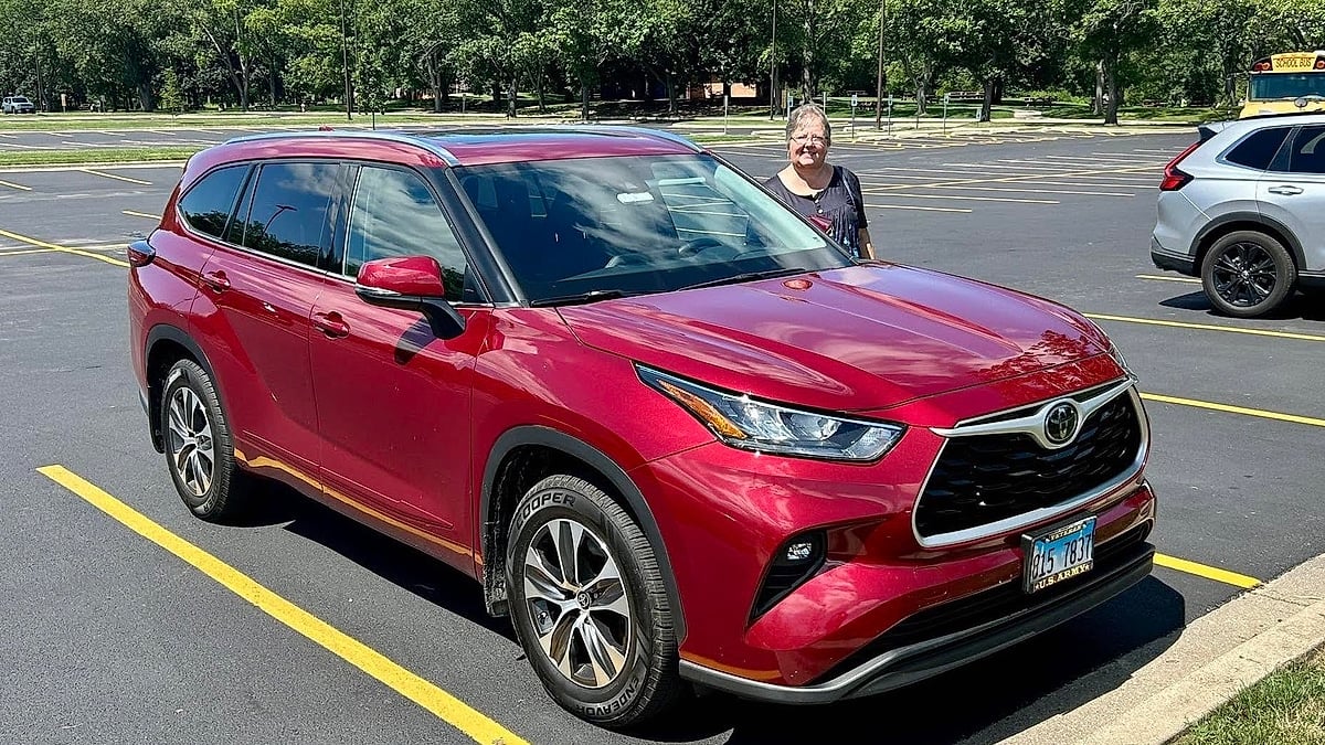 John Bratcher's wife standing by their 2020 Toyota Highlander with 90,000 miles in Illinois
