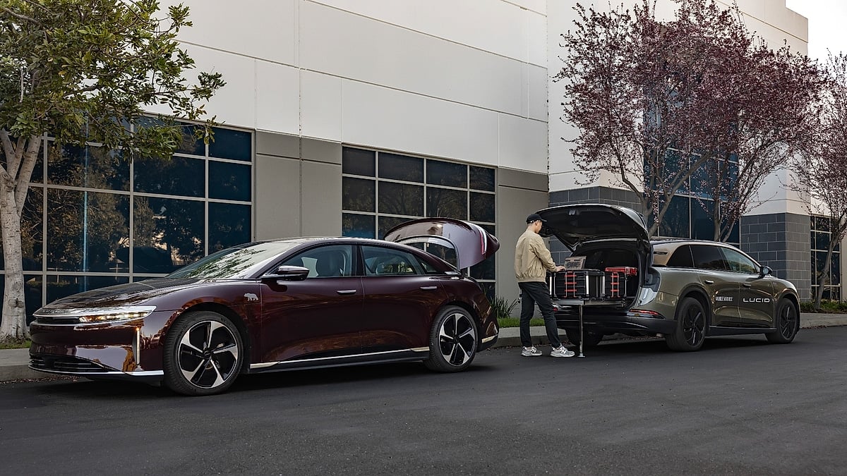 Lucid Air sedan receiving mobile service support from Lucid Gravity SUV with technician unloading equipment