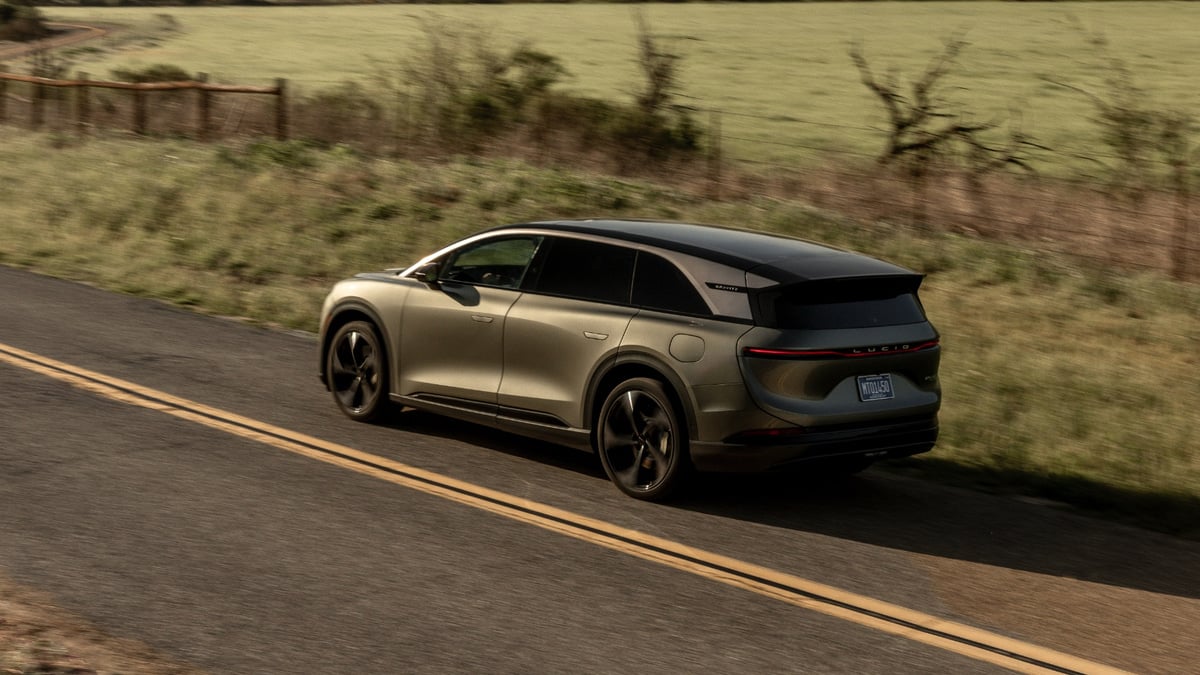 lucid-gravity-suv-rear-view-driving-country-road