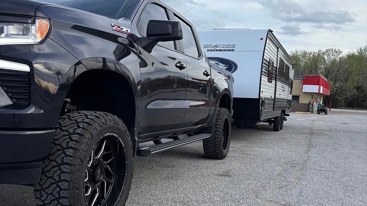 Lupe Herrera Jr.'s Chevy Silverado 2500 pulling a large travel trailer