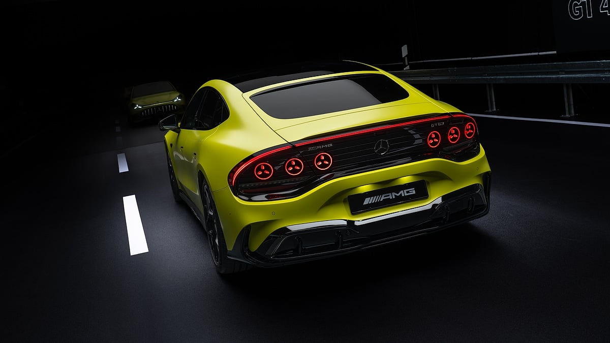 Yellow Mercedes-AMG GT 4-Door Coupe shown from the rear in a dark tunnel with illuminated taillights.
