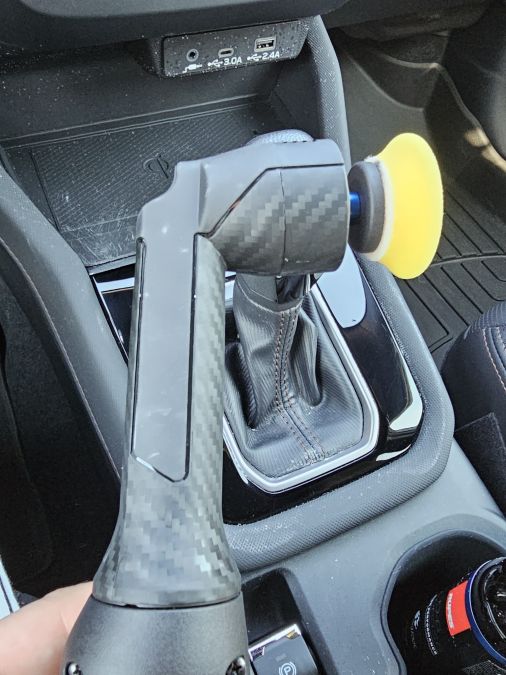 A polisher is shown restoring piano-black interior trim