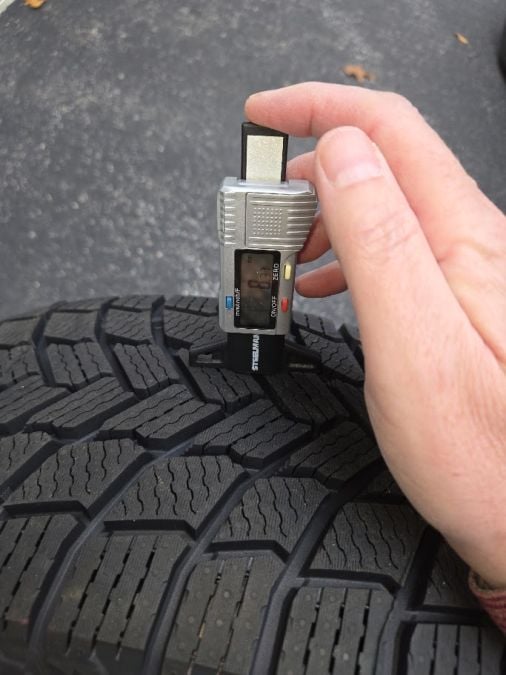 A Micheline X-ICE tire's tread depth is measured