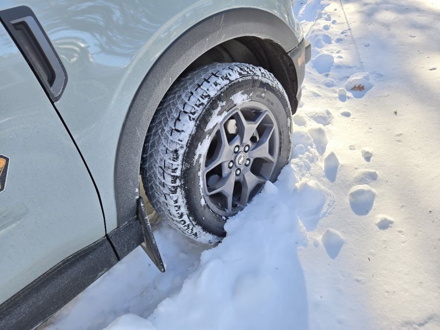 A vehicle with winter tries is shown