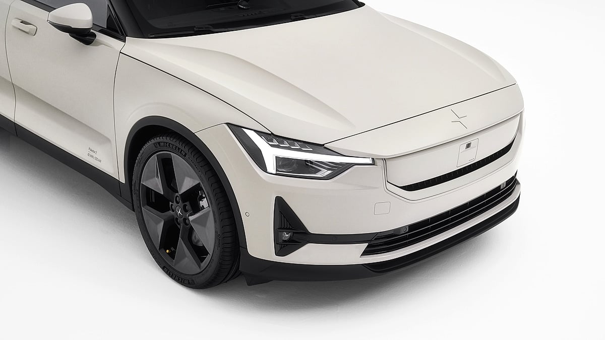 Close-up of a white Polestar 2 front end in a studio setting.