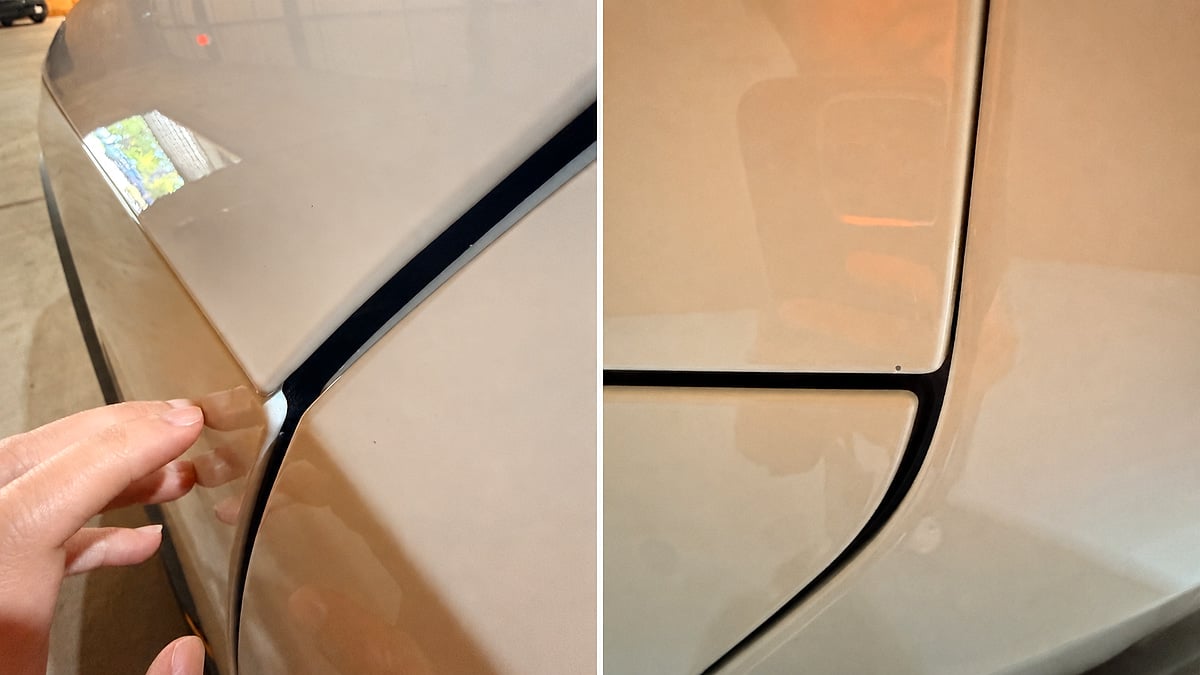 Close-up comparison of Rivian R2 fender panel gaps and paint finish with a hand pointing to the area.
