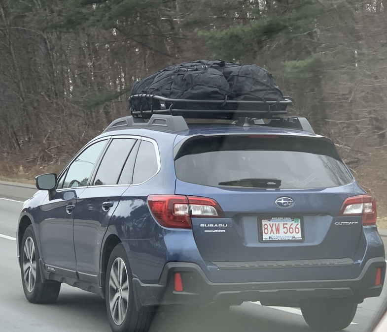 A roof-mounted cargo bag is shown