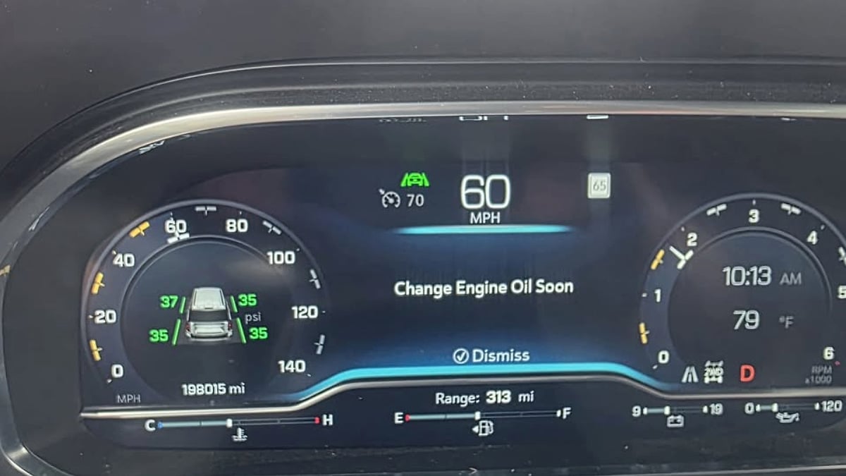 Dashboard display from a high-mileage 2023 Chevy Suburban LT showing nearly 200,000 miles and a change engine oil reminder.