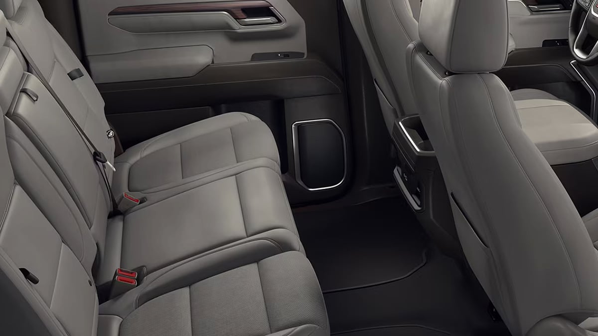 Rear seating area of a 2025 GMC Sierra 1500 showing spacious legroom and a wide bench seat for passengers.